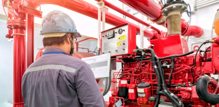 Engineers inspecting pump system
